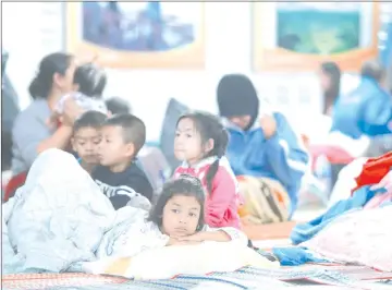  ??  ?? Children who were evacuated from their homes are seen at a evacuation centre. — Reuters photo