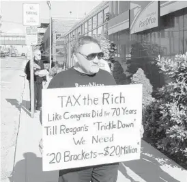  ?? DERIK HOLTMANN/ TNS ?? This file photo shows James Hodgkinson, who was killed June 14 after opening fire on a congressio­nal baseball practice, protesting outside a U.S. post office in 2012. Hodgkinson was a Bernie Sanders supporter and staunch critic of Donald Trump.