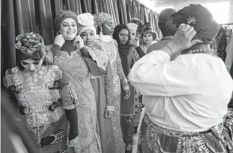  ?? Photos by Annie Mulligan / Contributo­r ?? Models line up to walk the runway at the Beyond the Veil fashion show, which had custom pieces from modest designers celebratin­g different cultures. “Seeing events like this gives you hope — despite everything going on in the world,” said Habiba Muya of Houston.