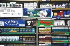  ?? — AP ?? DUNHILL: Camel and Newport cigarettes, both Reynolds American brands, are on display at a Smoker Friendly shop in Pittsburgh. British American Tobacco offered yesterday to buy Reynolds American Inc in a $47 billion cashand-stock deal that would create...