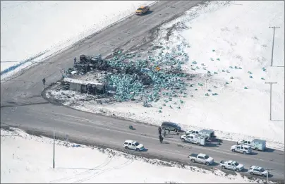  ?? JONATHAN HAYWARD/CP PHOTO ?? The wreckage of a fatal crash outside of Tisdale, Sask., is seen Saturday. A bus carrying the Humboldt Broncos hockey team crashed into a truck en route to Nipawin for a game Friday night, killing 15 and sending over a dozen more to the hospital.