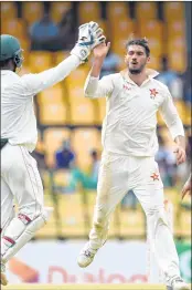  ??  ?? Zimbabwe captain Graeme Cremer celebrates with his teammates after he dismissed Sri Lankan captain Dinesh Chandimal during the second day of play at the Premadasa Stadium in Colombo on Saturday.