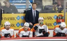  ?? GENE J. PUSKAR — THE ASSOCIATED PRESS ?? Flyers coach Dave Hakstol is in deep frown mode as he stands behind (from left) Matt Read, Jori Lehtera, Claude Giroux and Jake Voracek during a Game 1 loss at PPG Paints Arena Wednesday night.