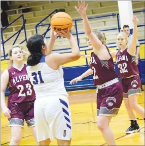  ?? Westside Eagle Observer/MIKE ECKELS ?? Surrounded by a pack of Lady Leopard defenders, Lady Bulldog Jackie Mendoza (31) tries for a field goal during the third quarter of the Decatur-Alpena girls’ basketball contest at Peterson Gym in Decatur Jan. 12. The Lady Leopards took the conference win, 65-30, over the Lady Bulldogs.