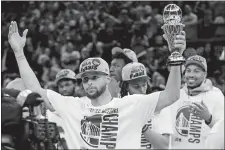  ?? JEFF CHIU/AP PHOTO ?? Golden State Warriors’ Stephen Curry holds up the conference finals MVP trophy after the Warriors defeated the Dallas Mavericks in Game 5 of the NBA Western Conference finals on Thursday in San Francisco.