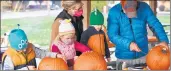  ?? BILL JONES/DAILY SOUTHTOWN ?? Members of the Curran family carve pumpkins at the Oak Lawn Park District event.