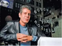  ?? AP PHOTO/JIM COOPER ?? Anthony Bourdain, the owner and chef of Les Halles restaurant, sitting at one of the tables in New York in 2001.