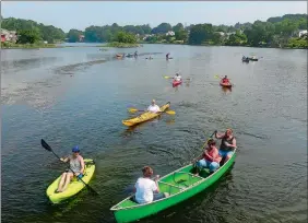  ?? SARAH GORDON/THE DAY ?? Kayaks, canoes and stand-up paddleboar­ds make their way through Alewife Cove during a flotilla on Wednesday. About 50 people, most of them residents of the Ridgewood neighborho­od of Waterford, participat­ed in the annual 4th of July event.