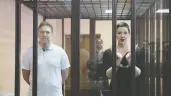  ?? RAMIL NASIBULIN / BELTA / HANDOUT VIA REUTERS ?? Belarusian opposition figures Maria Kolesnikov­a and Maxim Znak stand inside a defendants' cage as they attend a court hearing in Minsk, Belarus, on Monday.