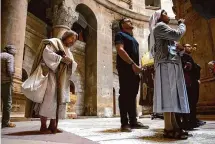  ?? ?? Carl James Joseph, dressed as Jesus, prays the the Church of the Holy Sepulchre on Good Friday in Jerusalem.