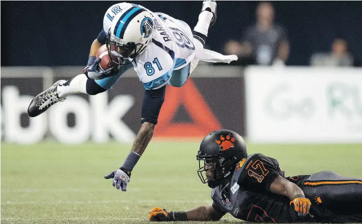  ?? — THE CANADIAN PRESS FILES ?? This tackle on Toronto Argonauts wide receiver Jason Barnes is one of the enduring moments from T.J. Lee’s first CFL start on Aug. 17, 2014.