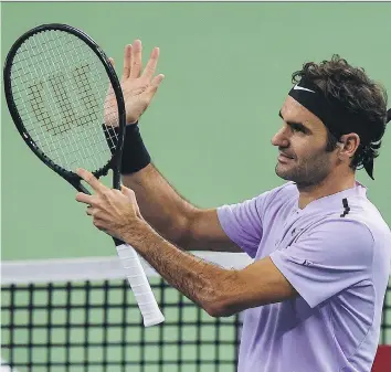  ?? CHANDAN KHANNA/AFP/GETTY IMAGES ?? Roger Federer advanced to the quarter-finals of the Shanghai Masters Thursday by beating Alexandr Dolgopolov 6-4, 6-2. The No. 2 seed will face Richard Gasquet in the next round.