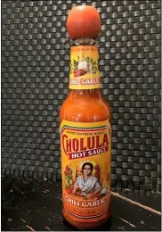  ?? CHARLES SHEEHAN — THE ASSOCIATED PRESS ?? A bottle of Cholula Hot Sauce is shown. Spice maker McCormick & Co. is buying the parent of Cholula Hot Sauce from private-equity firm L Catteron for $800 million, expanding its reach in the hot sauce category.