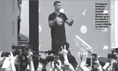  ??  ?? Portuguese footballer Cristiano Ronaldo gestures the thumbs up as he attends a promotiona­l event in Beijing on Thursday.