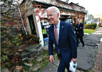  ?? Associated Press ?? ■ Former U.S. Vice President Joe Biden leaves Hank’s Hogies with some treats after speaking Wednesday at the Scranton Cultural Center in Scranton Pa.