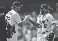  ?? MARK J. TERRILL/THE ASSOCIATED PRESS ?? Los Angeles Dodgers third baseman Justin Turner, right, seen celebratin­g with ace Clayton Kershaw earlier this month, says the team’s hot play of late is no “five-week thing.”
