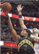  ?? GETTY IMAGES ?? Raptors guard Kyle Lowry goes up against the Wizards’ Marcin Gortat for two of his 24 points in Toronto’s series clinching victory.