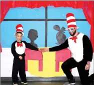  ?? Janelle Jessen/Herald-Leader ?? First-grade student Axel Flores and custodian Michael Rowley were both ready to entertain Sally and her brother from Dr. Suess’ famous book, The Cat in the Hat.