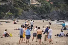  ?? Nick Otto / Special to The Chronicle ?? Some people clearly were not practicing social distancing at crowded Baker Beach in San Francisco on Saturday.