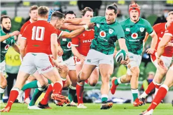  ?? — AFP file photo ?? Ireland’s wing James Lowe (centre) off-loads in the tackle during the Autumn Nations Cup internatio­nal rugby union match between Ireland and Wales at Aviva Stadium in Dublin.