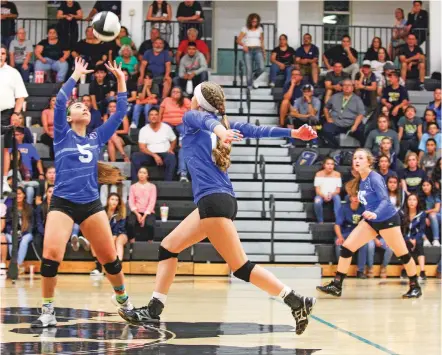  ?? PHOTOS BY GABRIELA CAMPOS/THE NEW MEXICAN ?? St. Michael’s Miquela Martinez sets a ball for teammate Mikayla Bohlman during an Aug. 24 nondistric­t match at Capital. Martinez and Bohlman are key players for the Lady Horsemen, who are off to a 5-1 start to the season.