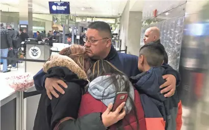  ?? NIRAJ WARIKOO/USA TODAY NETWORK ?? Jorge Garcia hugs his family Jan. 15 before being deported from Detroit to Mexico.