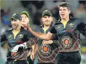  ?? AP ?? To recognise Indigenous Australian­s, their cricket team donned black jerseys with aboriginal patterns for the T20I against India.