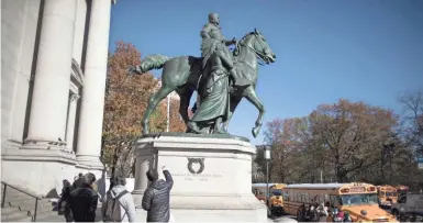  ?? MARY ALTAFFER/AP ?? The statue of Theodore Roosevelt outside the American Museum of Natural history in New York will be removed. Roosevelt’s horse is flanked by Native American and African men.