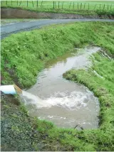  ??  ?? LEFT: Stacked culverts under the filter fabric work together during heavy rainfall. ABOVE AND RIGHT: the koru-shaped swale in action. Note how calm and slow the water is by the time it heads over the wide, level sill, compared to its speed coming out of the pipe in the middle image.