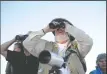  ??  ?? Above right: California Department of Fish and Wildlife volunteer docent Alan England looks for Sandhill cranes during the Sandhill Crane Tour on the first night of Sandhill Crane Festival at Woodbridge Ecological Reserve outside Lodi on Nov. 6, 2015....