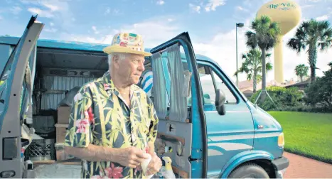  ?? COURTESY ?? Dennis Dean with the blue van that is his home at the Villages, which is featured in “Some Kind of Heaven.”