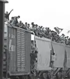  ?? MOISES CASTILLO/AP ?? Central American migrants ride atop a freight train in Ixtepec, Mexico, during their journey toward the U.S.-Mexican border in April.