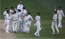  ?? Photograph: Matt Turner/EPA ?? Australia celebrate after Jos Buttler steps on his wicket and is out bowled by Jhye Richardson at Adelaide Oval.