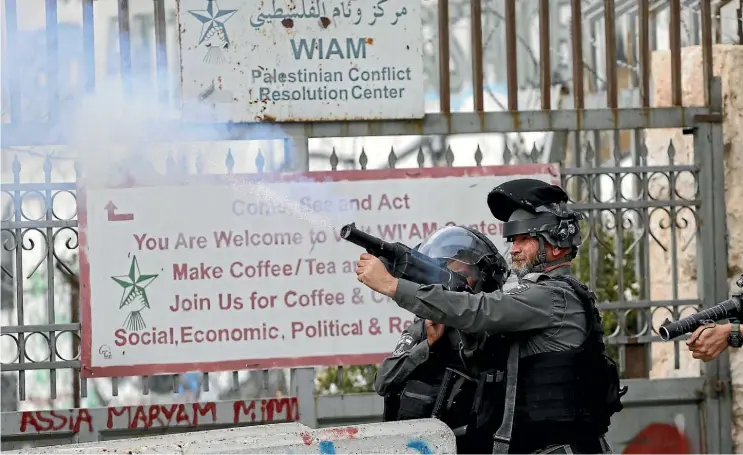  ??  ?? Israeli border police fire tear gas at Palestinia­n protesters in Bethlehem yesterday. The town revered as Jesus’s birthplace is packed with Christmas tourists despite the anger over US President Donald Trump’s Jerusalem announceme­nt.