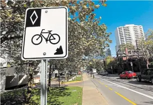  ?? BARRY GRAY THE HAMILTON SPECTATOR FILE PHOTO ?? Signage and lane markings for the bike lane on Bay Street North. The city hopes cycling — rather than single-occupant car commuting — will help replace those lost transit trips.