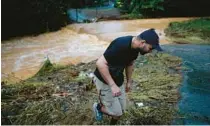  ?? JOSE JIMENEZ/GETTY ?? A man walks away from the Turabo River, flooded by Hurricane Fiona, on Monday in Caguas, Puerto Rico.