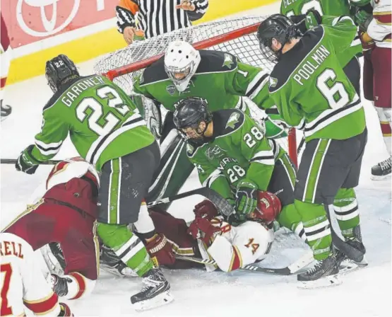  ?? Seth McConnell, Special to The Denver Post ?? Things get physical in front of the North Dakota net during the closing seconds of the third period on Friday night at Magness Arena as the Denver Pioneers do battle with the Fighting Hawks. North Dakota won 5-4, and the teams will meet again Saturday...