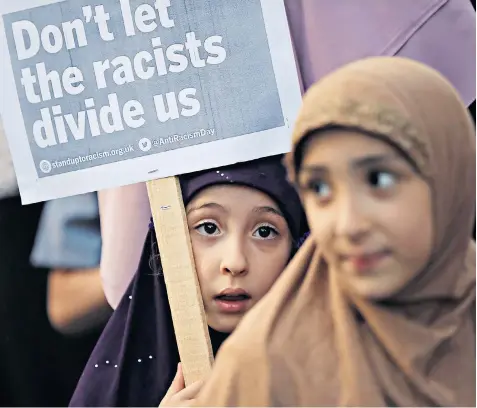  ??  ?? Children attend a vigil yesterday outside Finsbury Park mosque in north London, close to where a van was driven at a group of Muslims, resulting in the death of a 52-year-old man