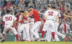  ?? USA TODAY SPORTS ?? The Red Sox’s Andrew Benintendi, third left, celebrates with teammates after their victory over the Yankees.