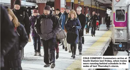  ?? STAFF FILE PHOTO BY FAITH NINIVAGGI ?? COLD COMFORT: Commuters arrive at South Station last Friday, when trains were running behind schedule in the wake of last Thursday’s storm.