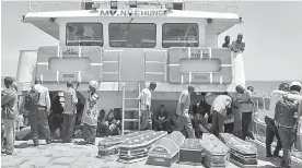  ?? Associated Press ?? ■ Coffins for the victims of the MV Nyerere passenger ferry are transporte­d by another ferry Saturday to Ukara Island, Tanzania.