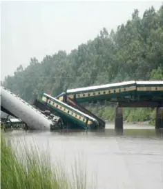  ?? —AP ?? LAHORE: Cars of a passenger train fall after a bridge collapse led a train into a canal in Wazirabad, near Lahore yesterday.