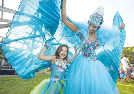  ?? (File Photo) ?? Olivia Campos of Rogers dances under the wings of Fatima Pollard of Fayettevil­le during last year’s Firefly Fling at the Botanical Garden of the Ozarks in Fayettevil­le. Volunteers are needed to count actual fireflies to figure out how their numbers are dwindling.