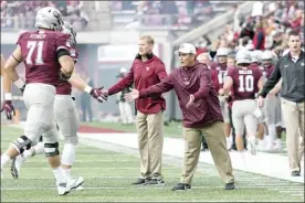  ?? UNIVERSITY OF MONTANA ATHLETICS photo ?? Jimmy Morimoto (with hat) is shown during a University of Montana game in 2018. Morimoto, a former Baldwin High School football player and coach, serves as the school’s assistant athletic director in charge of football operations.