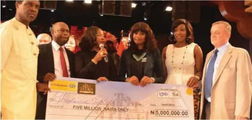  ??  ?? The Next Titan Season 1 winner,Iroghama Ogbeifun (3rd right), receiving the N5 million cheque courtesy of Heritage Bank at the prize presentati­on in 2013, in Lagos