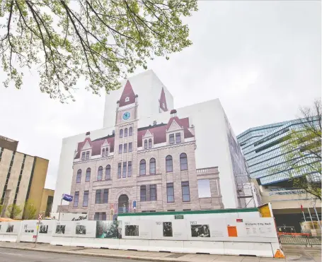  ?? GAVIN YOUNG ?? The constructi­on wrapping on the city’s historic city hall is scheduled to be removed in June after a three-year-restoratio­n. Work that cost $34 million involved extensive work on the sandstone facade, including replacing about 2,400 of the original blocks.