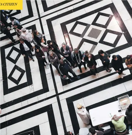  ?? CHRISTINE POUJOULAT/AFP/GETTY IMAGES ?? People queue at a polling station in Marseille, southern France, on Sunday during the first round of the French presidenti­al election.