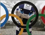  ?? KIM KYUNGHOON, POOL — THE ASSOCIATED PRESS, FILE ?? games,” Hashimoto said.
Tokyo 2020 Olympic Games mascot Miraitowa poses with a display of the Olympic symbol after an unveiling ceremony on Wednesday.