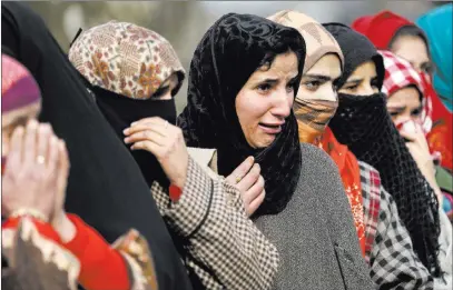  ?? Mukhtar Khan ?? The Associated Press Kashmiri women wail Tuesday as they watch the funeral procession of Noor Mohammed, a top rebel commander at Aripal, 30 miles south of Srinagar Indian-controlled Kashmir.