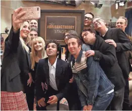  ?? WARNER BROS. ?? Kaley Cuoco takes a group photo of “The Big Bang Theory” cast and producers after the soundstage was named for the series.
